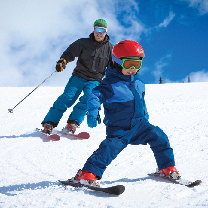  A man and a child skiing down a hill at Horseshoe Resort